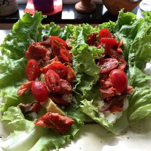 Lettuce wrapped around cream cheese, avocado, smoked salmon, tomato, red onion, Frank's hot sauce, salt & pepper.